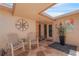 Charming front porch with stone flooring, seating, and decorative accents at 120 Villa Dr # 120, Osprey, FL 34229