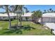 Charming home with a manicured lawn, mature palm trees, and an attached two-car garage at 120 Villa Dr # 120, Osprey, FL 34229