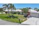 Well-manicured lawn and landscaping, mature palm trees, and tile roof create curb appeal at 120 Villa Dr # 120, Osprey, FL 34229