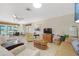 Bright living room with tile floors, comfortable seating, and sliding doors to the backyard with canal views at 120 Villa Dr # 120, Osprey, FL 34229