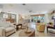 Open living area with stone accent wall, tile flooring, and views of the dining and kitchen areas at 120 Villa Dr # 120, Osprey, FL 34229