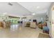 Open floor plan with comfortable seating, view of dining room and access to the outdoors at 120 Villa Dr # 120, Osprey, FL 34229
