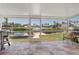 Screened-in patio features a view of the waterway and nearby boat docks at 120 Villa Dr # 120, Osprey, FL 34229