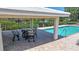 Community pool with covered patio space perfect for relaxing and entertaining at 120 Villa Dr # 120, Osprey, FL 34229