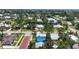 Bright blue home with lush green landscaping and silver metal roof in a charming neighborhood, ready for new homeowners at 121 Dolly St, Punta Gorda, FL 33950