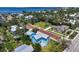 Aerial view showcases a light blue home with a charming backyard and a picturesque neighborhood setting at 121 Dolly St, Punta Gorda, FL 33950