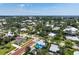 Charming blue house nestled among lush trees and greenery in a quiet neighborhood with beautiful landscaping at 121 Dolly St, Punta Gorda, FL 33950