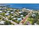Aerial view of light blue home in a charming neighborhood features mature trees and proximity to the bay, offering serene living at 121 Dolly St, Punta Gorda, FL 33950