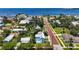 Light blue home's aerial view shows proximity to the bay in a mature landscape, offering serene living and charming street appeal at 121 Dolly St, Punta Gorda, FL 33950