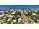 Light blue home's aerial view shows it's nestled in a waterfront community with mature landscaping and charming street appeal at 121 Dolly St, Punta Gorda, FL 33950