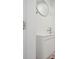 Modern bathroom featuring a floating vanity, round mirror, and minimalist design at 121 Dolly St, Punta Gorda, FL 33950