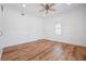 Bright bedroom features clean white walls, wood-look floors, and a ceiling fan at 121 Dolly St, Punta Gorda, FL 33950