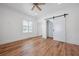 A well-lit bedroom showcases a sliding closet door and natural wood flooring at 121 Dolly St, Punta Gorda, FL 33950
