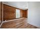 Bright bedroom featuring wood paneled walls, wood flooring and natural light at 121 Dolly St, Punta Gorda, FL 33950