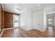 Bright bedroom featuring wood paneled walls, wood flooring and view to backyard at 121 Dolly St, Punta Gorda, FL 33950