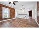 Bright bedroom featuring wooden accent wall, hardwood floors, and a ceiling fan at 121 Dolly St, Punta Gorda, FL 33950