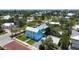 Stunning two-story blue home with a metal roof, yellow doors, and bright green lawn, ready for move-in at 121 Dolly St, Punta Gorda, FL 33950