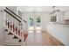 Bright home interior view with staircase, wood floors, natural light, and modern light fixtures at 121 Dolly St, Punta Gorda, FL 33950