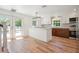 Modern kitchen with island, white cabinets, stainless steel appliances, and hardwood flooring at 121 Dolly St, Punta Gorda, FL 33950