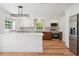 Bright kitchen with white cabinets, stainless steel appliances, and modern lighting at 121 Dolly St, Punta Gorda, FL 33950