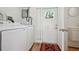 Bright laundry room with modern washer, dryer, and access to the backyard via the door and sidelight at 121 Dolly St, Punta Gorda, FL 33950