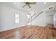 Bright living room with stairs, hardwood flooring, and access to other rooms at 121 Dolly St, Punta Gorda, FL 33950