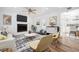 Bright living room with fireplace, television, stylish decor, and adjacent to kitchen at 121 Dolly St, Punta Gorda, FL 33950