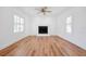 Bright, spacious living room with fireplace and natural light from plantation shuttered windows at 121 Dolly St, Punta Gorda, FL 33950