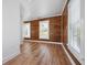 Bright living room features hardwood floors, wooden accent walls, and natural light at 121 Dolly St, Punta Gorda, FL 33950