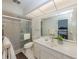 Bathroom featuring a glass-enclosed shower, a toilet, and a vanity with sink and mirror at 1231 Pine Needle Rd, Venice, FL 34285
