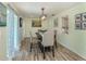 Dining room with stylish light fixture and sliding glass doors for indoor-outdoor dining experience at 1231 Pine Needle Rd, Venice, FL 34285