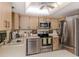 Kitchen features stainless steel appliances, wood cabinets, ample counter space, and stylish decor at 1231 Pine Needle Rd, Venice, FL 34285