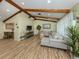 Spacious living room featuring wood floors, exposed beams, and plenty of natural light at 1231 Pine Needle Rd, Venice, FL 34285