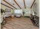 Spacious living room featuring wood floors, exposed beams, and plenty of natural light at 1231 Pine Needle Rd, Venice, FL 34285