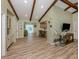 Open-concept living area with wood-look floors and views to other living spaces at 1231 Pine Needle Rd, Venice, FL 34285