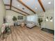 Spacious living room featuring wood floors, exposed beams, and plenty of natural light at 1231 Pine Needle Rd, Venice, FL 34285