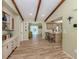 Open-concept living area with wood-look floors and views to other living spaces at 1231 Pine Needle Rd, Venice, FL 34285