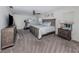 Spacious main bedroom with large bed, ceiling fan, and natural light from two windows at 1231 Pine Needle Rd, Venice, FL 34285