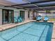 Inviting screened-in pool area with lounge chairs and outdoor seating for relaxation and enjoyment at 1231 Pine Needle Rd, Venice, FL 34285