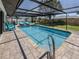 Large screened-in pool with brick pavers, sun loungers and fenced-in backyard at 1231 Pine Needle Rd, Venice, FL 34285