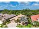 High angle view of a beautiful home with mature trees, lush landscaping and scenic views at 1241 Creek Nine Dr, North Port, FL 34291