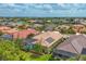 An elevated perspective of the property, displaying the pool, screened lanai, and the home's tile roof at 1241 Creek Nine Dr, North Port, FL 34291
