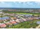 Aerial view showcasing a golf course community featuring well-maintained lawns, lakes, and diverse home styles at 1241 Creek Nine Dr, North Port, FL 34291