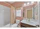 Bathroom features a tub, shower, toilet, window and vanity with sink at 1241 Creek Nine Dr, North Port, FL 34291