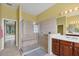 Bright bathroom features a glass shower and updated vanity with plenty of counter space at 1241 Creek Nine Dr, North Port, FL 34291