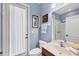 Well-lit bathroom showcases a vanity with sink and combination tub/shower, conveniently located near the door at 1241 Creek Nine Dr, North Port, FL 34291