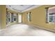 Bedroom features neutral carpet, decorative trey ceiling and large windows at 1241 Creek Nine Dr, North Port, FL 34291