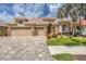 Stunning single-Gathering home featuring a tile roof, lush landscaping, and a brick paver driveway at 1241 Creek Nine Dr, North Port, FL 34291