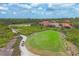 Scenic aerial view of a golf course with lush greenery, manicured lawns, and a smooth cart path at 1241 Creek Nine Dr, North Port, FL 34291