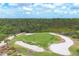 Picturesque golf course with sand traps, players, and lush green grass, perfect for an afternoon game at 1241 Creek Nine Dr, North Port, FL 34291